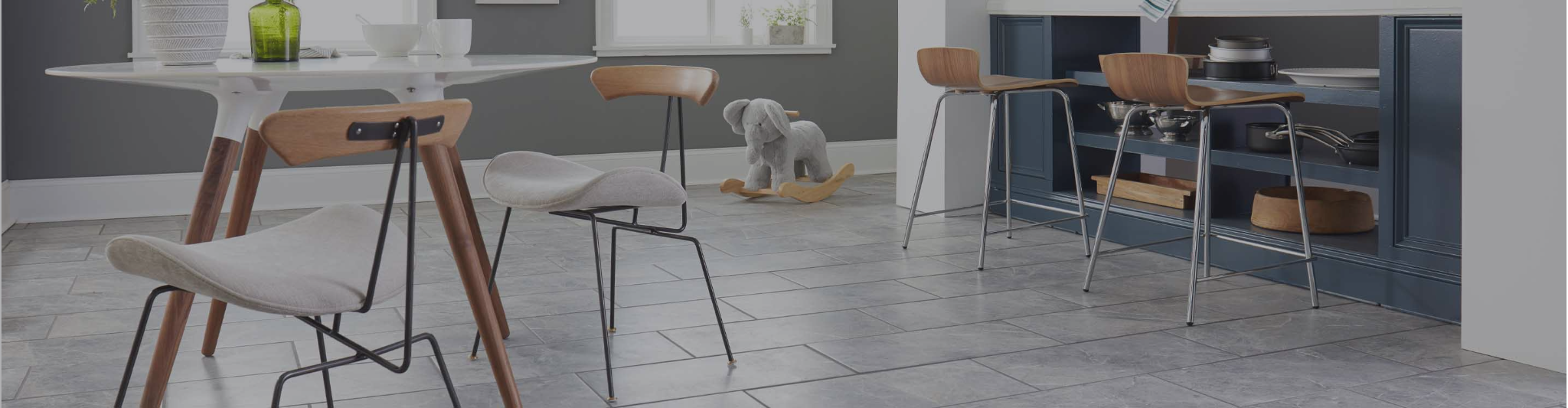 Gray large format tile flooring in a dining area